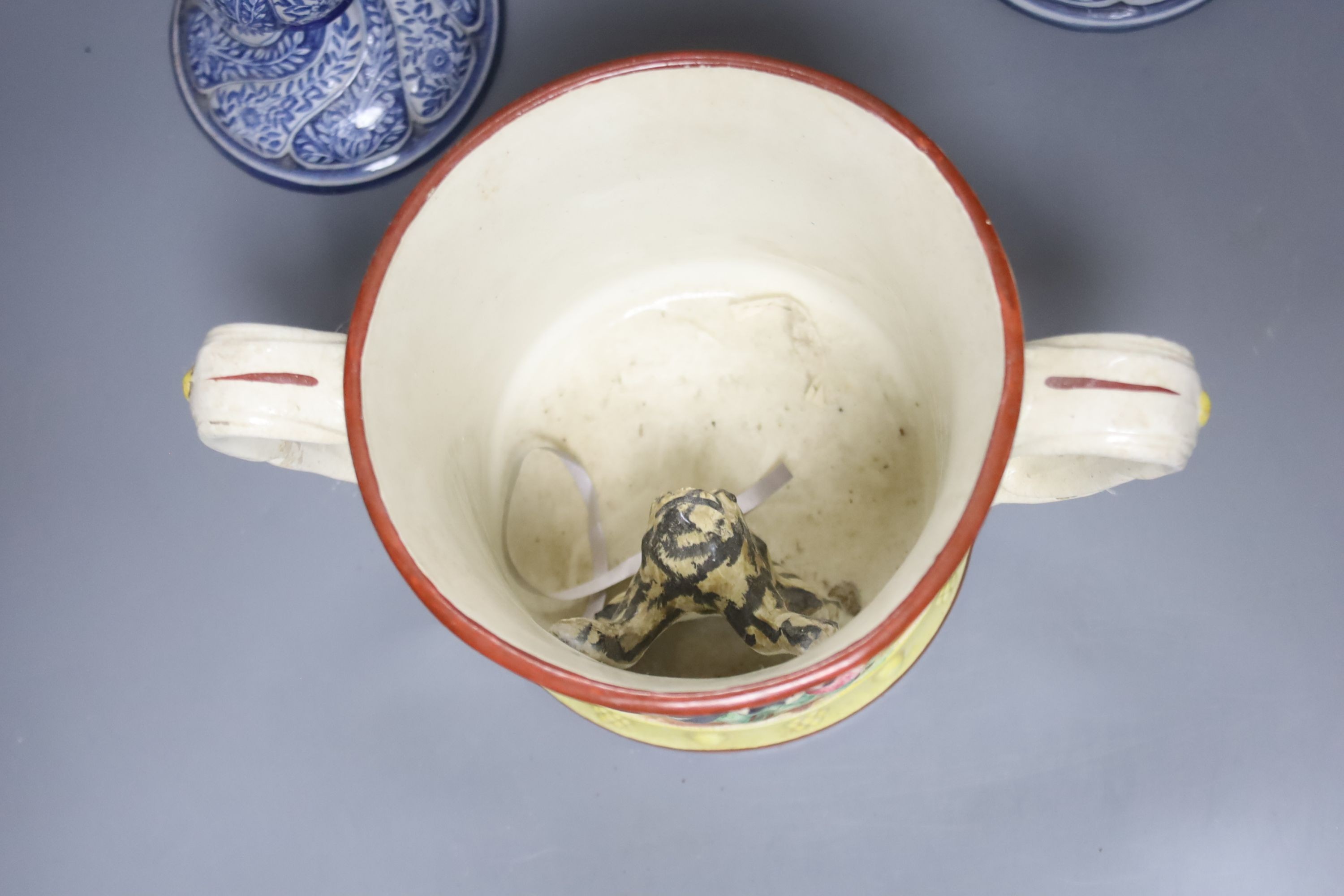 A Staffordshire pottery ‘duck’ tureen and cover, 23cm, a pair of faience candlesticks, Staffordshire figures of dogs, sheep and a zebra and a two handled loving mug